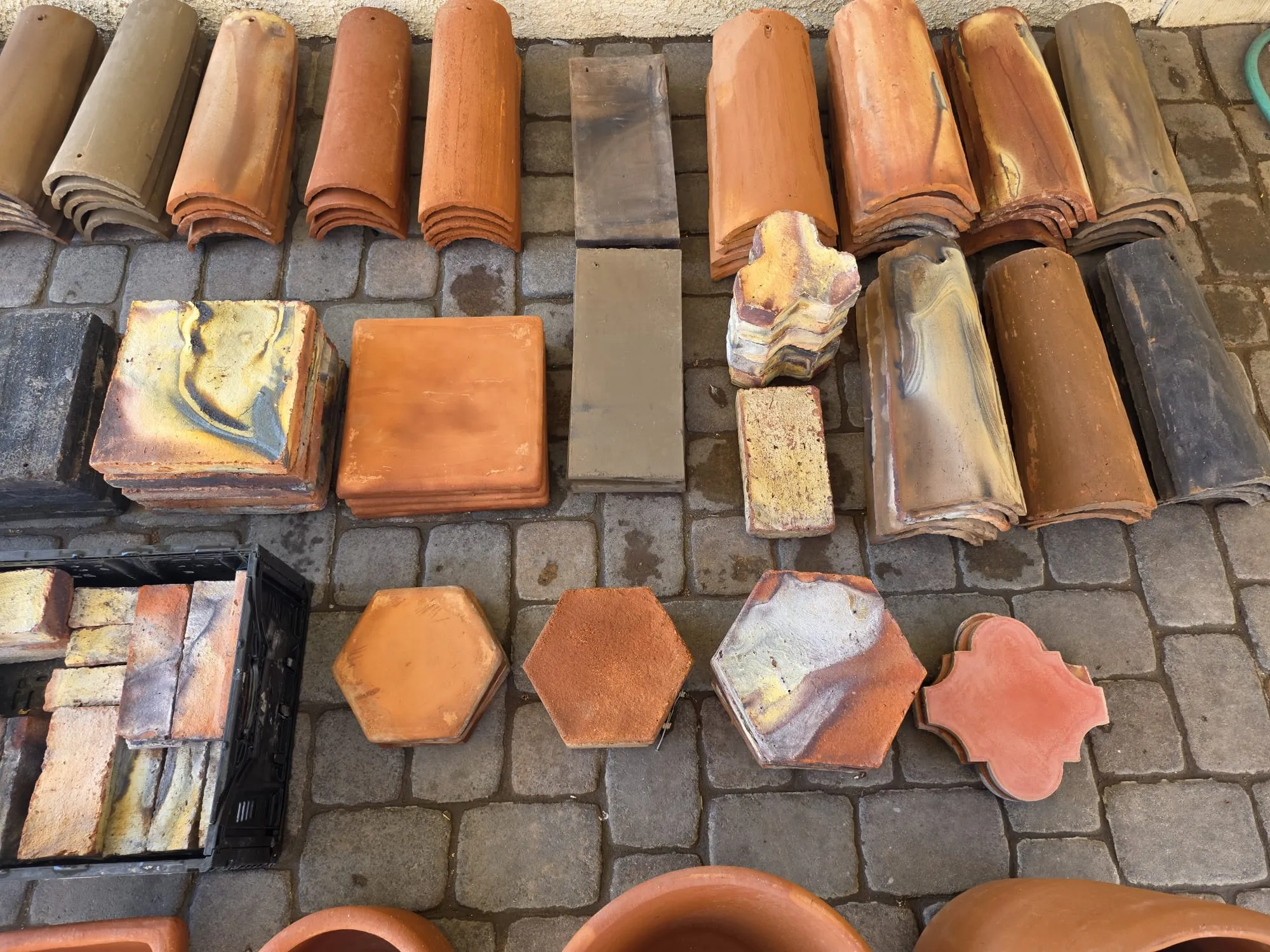 Overhead collection of roof tile, brick, pavers, and decorative clay shapes
